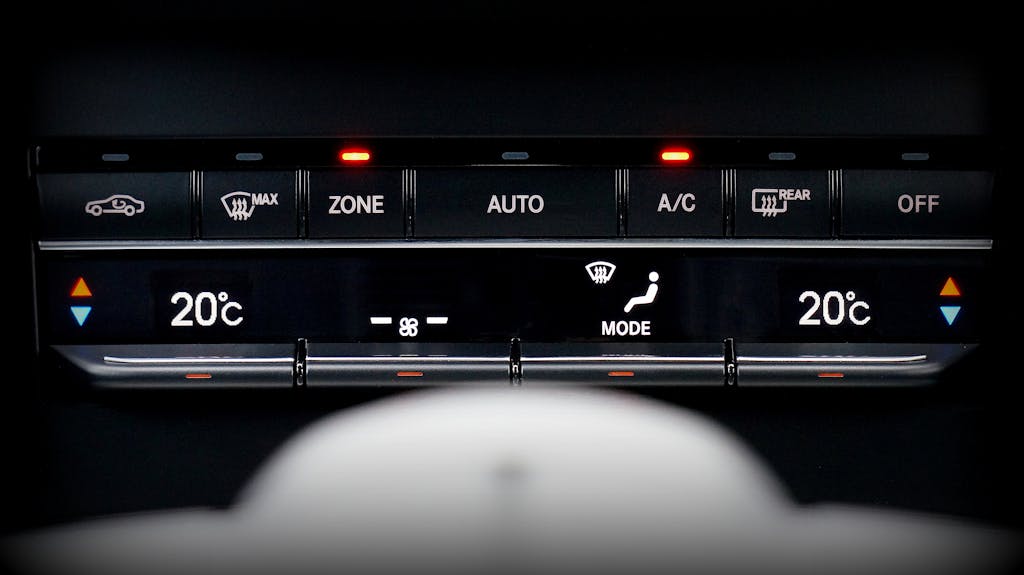Close-up image of a car's climate control panel with digital temperature display.